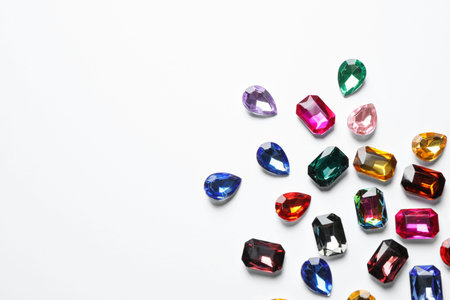 Different beautiful gemstones on white background, top viewの写真素材