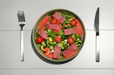 Tasty salad with red fish on light wooden table, flat layの写真素材