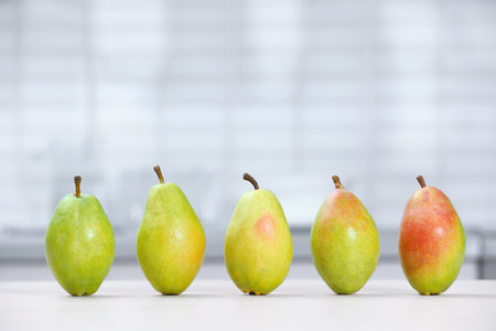 Fresh ripe pears on a white table in the kitchen. Space for textの写真素材