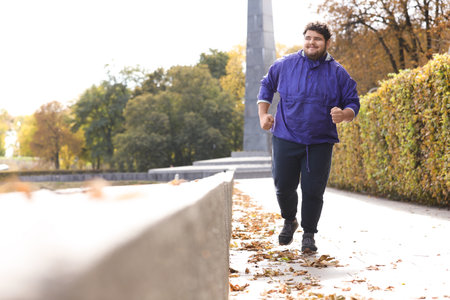Young overweight man running in the park. fitness lifestyleの写真素材