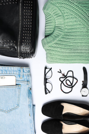 Stylish female autumn outfit and accessories on white background, flat lay. trendy warm clothesの写真素材