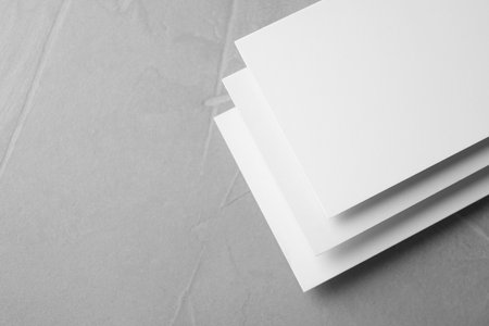 Blank business cards on light gray stone background, closeup. Mock up designの写真素材