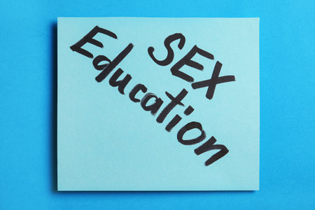 Note with phrase "SEX EDUCATION" on blue background, top viewの写真素材