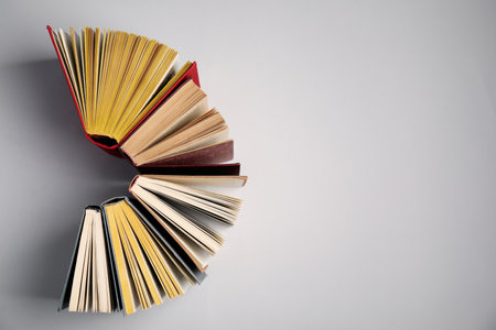 Hardcover books on gray background, flat lay. Space for textの写真素材