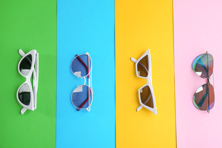 Stylish sunglasses on color background, flat lay. summer timeの写真素材