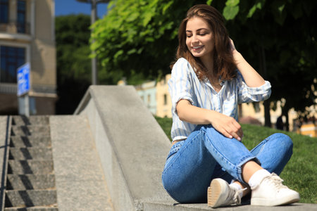 Beautiful young woman outdoors on sunny day. Space for textの写真素材