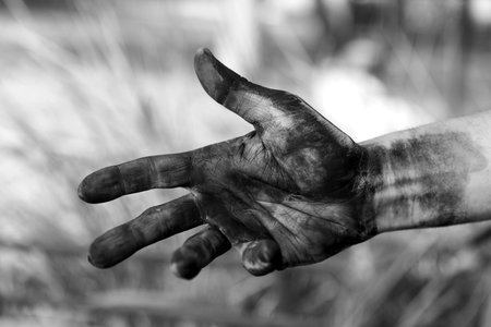 Dirty worker on blurred background, closeup of hand. black and white effectの写真素材