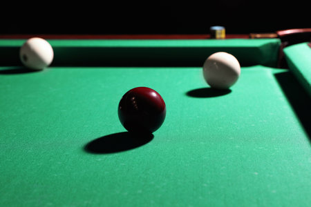 Balls and chalk on modern billiard table
