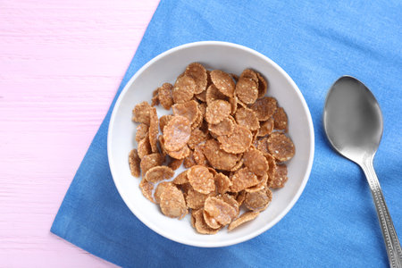 Cornflakes with milk on pink wooden table, flat lay. healthy breakfast