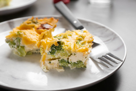 Pieces of tasty broccoli casserole on gray tableの写真素材