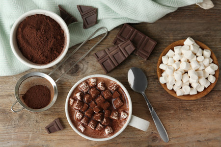 Composition with delicious hot cocoa drink and marshmallows on wooden background, flat layの写真素材