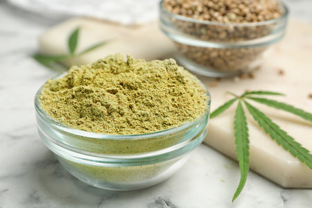 Bowl of hemp protein powder on marble table, closeupの写真素材