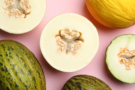 Flat lay composition with tasty melon on pink background