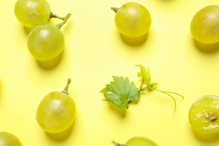 Flat lay composition with fresh ripe juicy grapes on yellow backgroundの写真素材