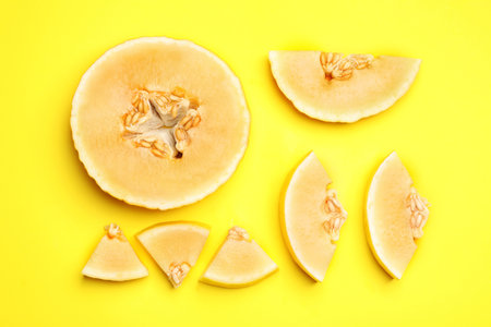 Flat lay composition with tasty melon on yellow backgroundの写真素材