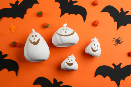Flat lay composition with Jack-o-Lantern candle holders on orange background. halloween decorの写真素材