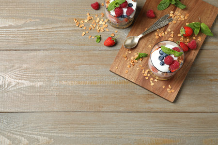 Healthy homemade granola dessert served on wooden table, flat lay. Space for textの写真素材