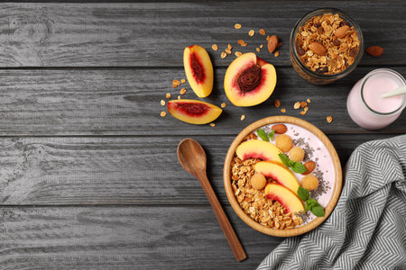 Healthy homemade granola with yogurt on gray wooden table, flat lay. Space for textの写真素材