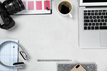 Flat lay composition with laptop, camera and color palette on gray stone table, space for text. Designer's workplaceの写真素材