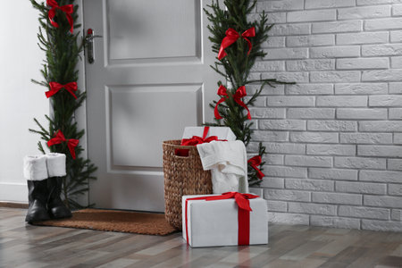 Stylish hallway interior with decorated door and Christmas gifts, space for textの写真素材
