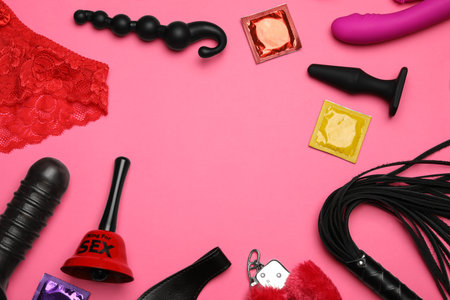 Different sex toys on pink background, flat lay. Space for textの写真素材