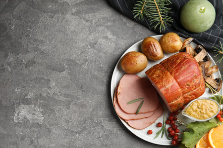 Flat lay composition with delicious ham on gray table, space for text. christmas dinnerの写真素材