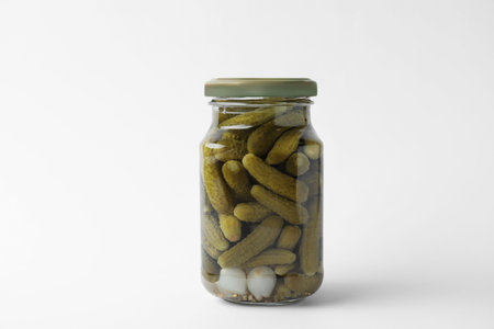 Jar with pickled gherkins on white backgroundの写真素材