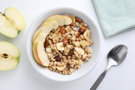 Flat lay composition with muesli and apples on white wooden table. healthy breakfastの写真素材