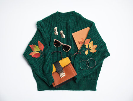 Warm clothes, autumn leaves and accessories on white background, top viewの写真素材