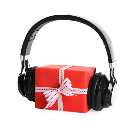 Gift box with headphones isolated on white. christmas music conceptの写真素材