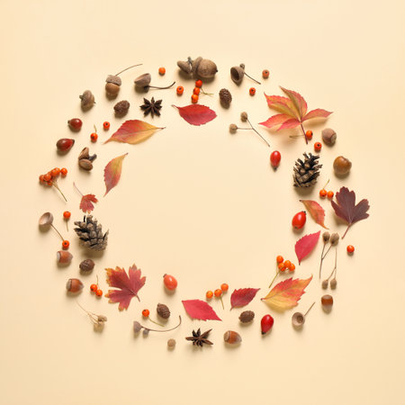 Frame made of autumn leaves on beige background, top view. Space for textの写真素材