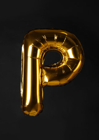 Golden letter P balloon on black backgroundの写真素材