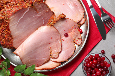 Flat lay composition with delicious ham for Christmas dinner on gray tableの写真素材