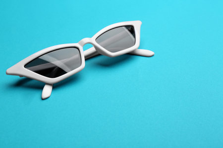 Stylish sunglasses on blue background, space for text. fashion accessoryの写真素材