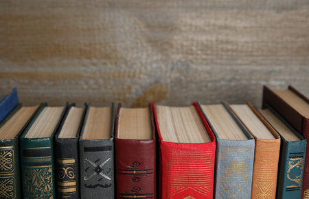 Stack of hardcover books on wooden background, closeup