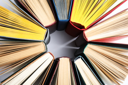 Circle made of hardcover books on white background, flat layの写真素材