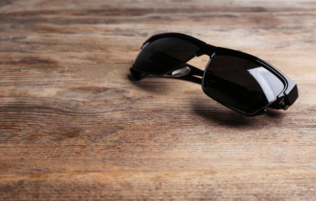 Stylish sunglasses on wooden background, space for text. fashion accessoryの写真素材