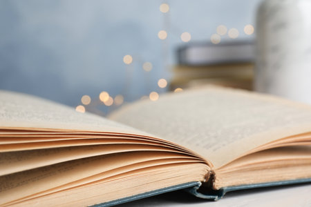 Open hardcover book on table against blurred background, closeupの写真素材