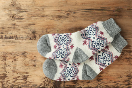 Knitted socks on wooden background, flat layの写真素材