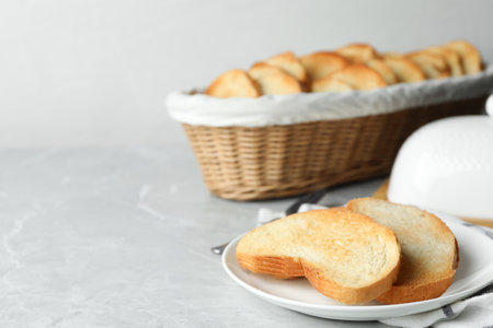Slices of toasted bread on gray table. Space for textの写真素材