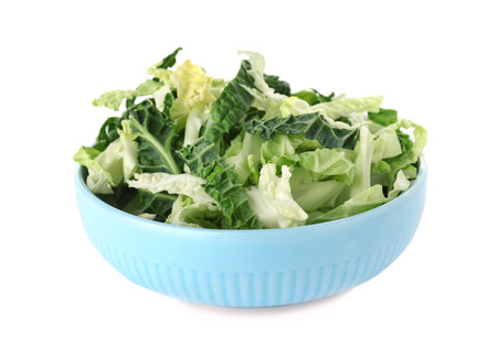 Chopped fresh green savoy cabbage in bowl on white backgroundの写真素材