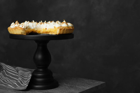 Stand with delicious lemon meringue pie on gray table, space for textの写真素材