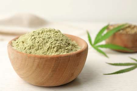 Bowl of hemp protein powder on white wooden table, closeupの写真素材