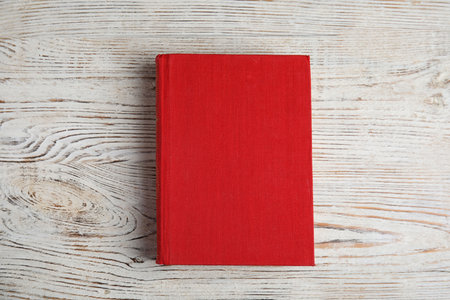 Hardcover book on light wooden table, top view. Space for textの写真素材