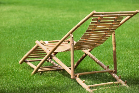 Wooden deck chair in beautiful garden on sunny dayの写真素材
