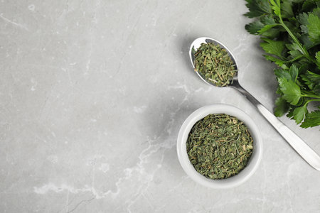 Flat lay composition with fresh and dried parsley on gray marble table. Space for textの写真素材
