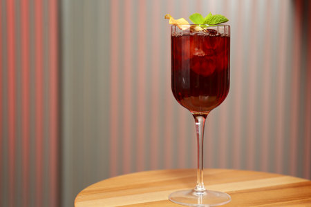 Glass of delicious cocktail with vodka on wooden table in bar. Space for textの写真素材