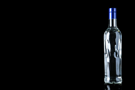 Bottle of vodka on black background. Space for textの写真素材