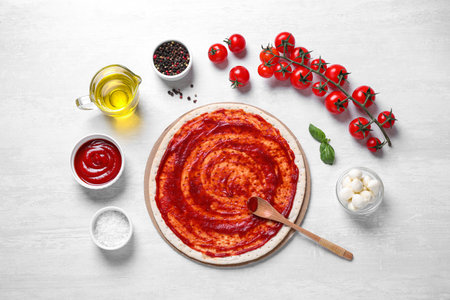 Flat lay composition with fresh ingredients for pizza Margherita on white tableの写真素材