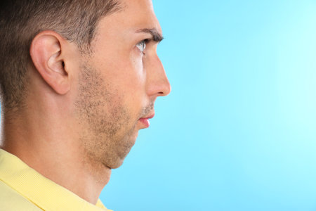 Young man with double chin on blue background. Space for textの写真素材